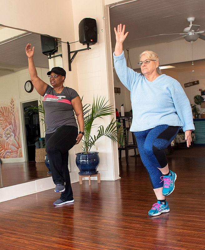 Cancer survivors doing strength exercises to rebuild after a cancer diagnosis