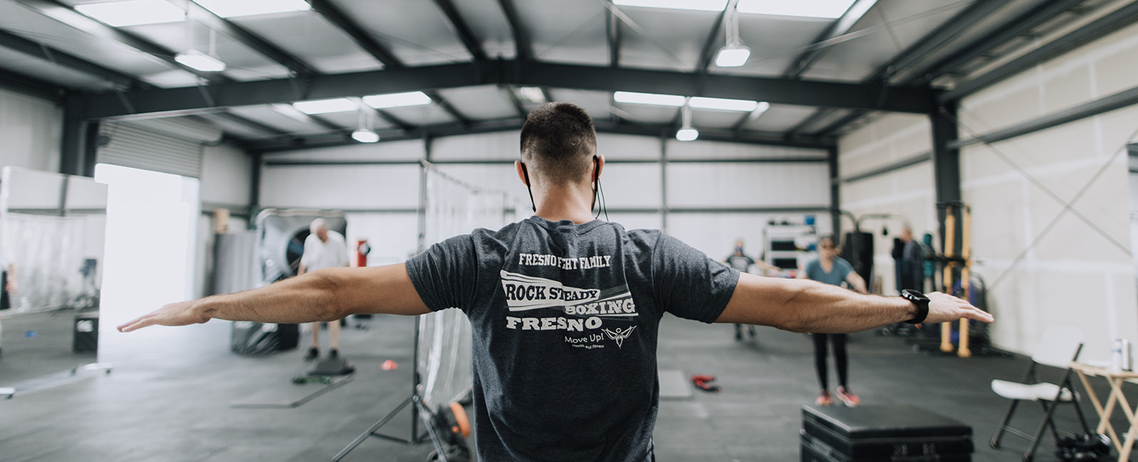 Exercise instructor leading members through a warm-up