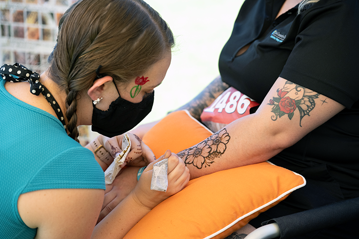 Attendees enjoying the face painting and henna at the Fresno Parkinson's benefit walk